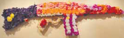 “Love” an automatic rifle made from artificial flowers by Marius Zavadskis (Photo: Shelly Elk)